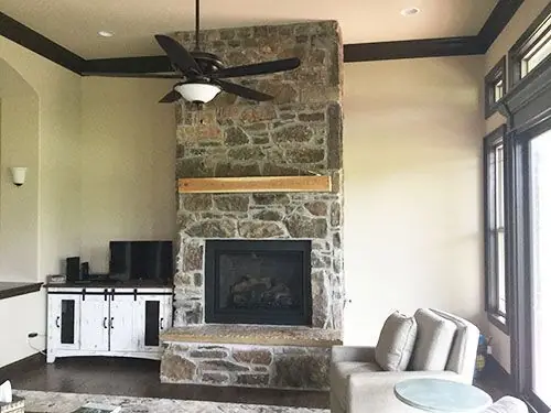 The same room with the fireplace finished in stone