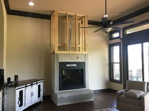 Fireplace installation in progress, with timber framing built over a new firebox